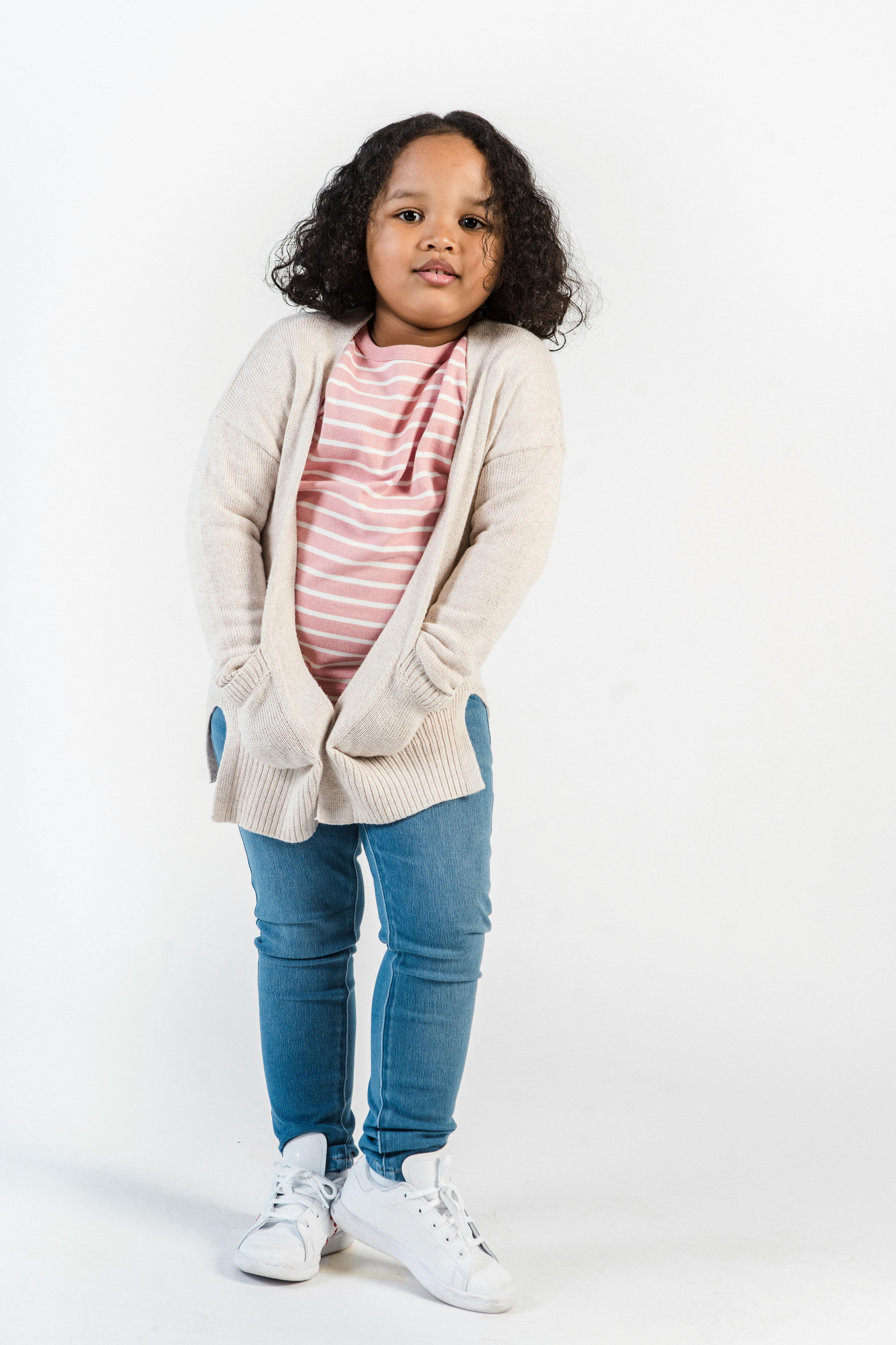 Positive black girl in casual outfit in studio · Free Stock Photo