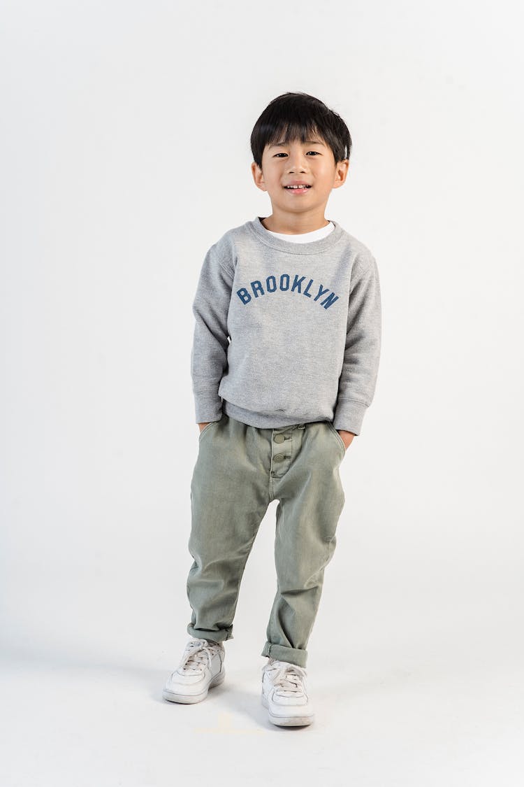 Stylish Ethnic Boy With Hands In Pockets In Studio