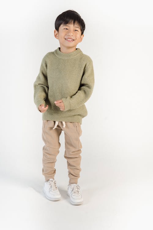 Boy in Green Sweater and Brown Pants