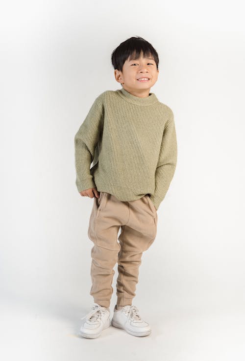 Stylish little cute Asian cheerful boy in trendy casual outfit