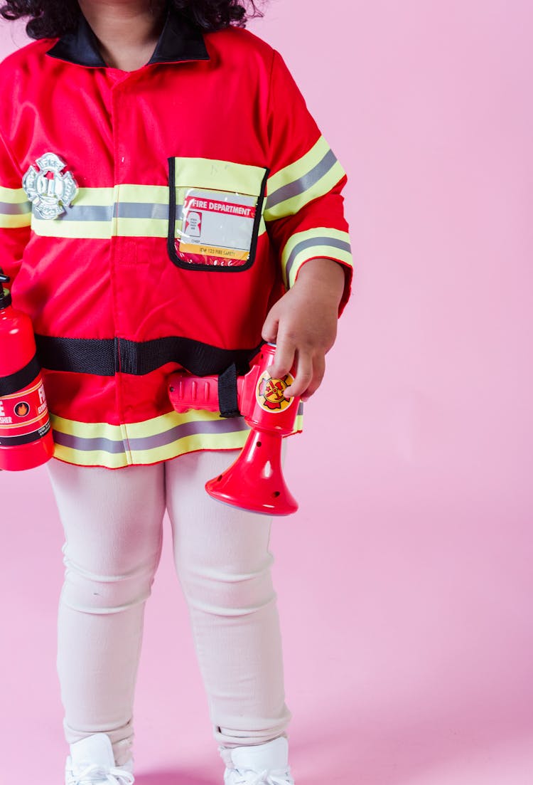 Faceless Ethnic Kid In Fireman Costume In Studio