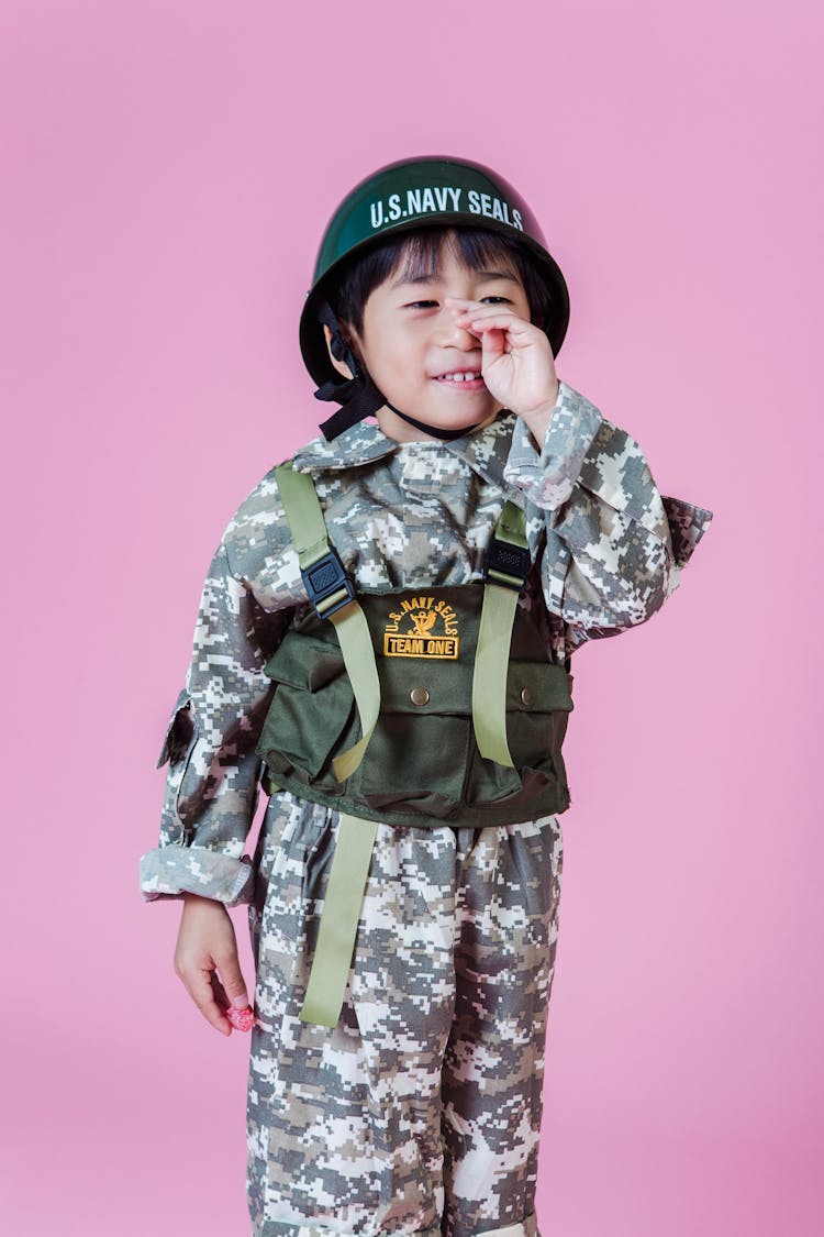 Ethnic Child In Military Uniform In Studio