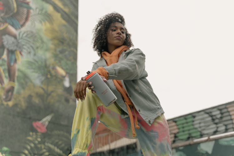 Low-Angle Shot Of A Woman Holding A Spray Paint Can