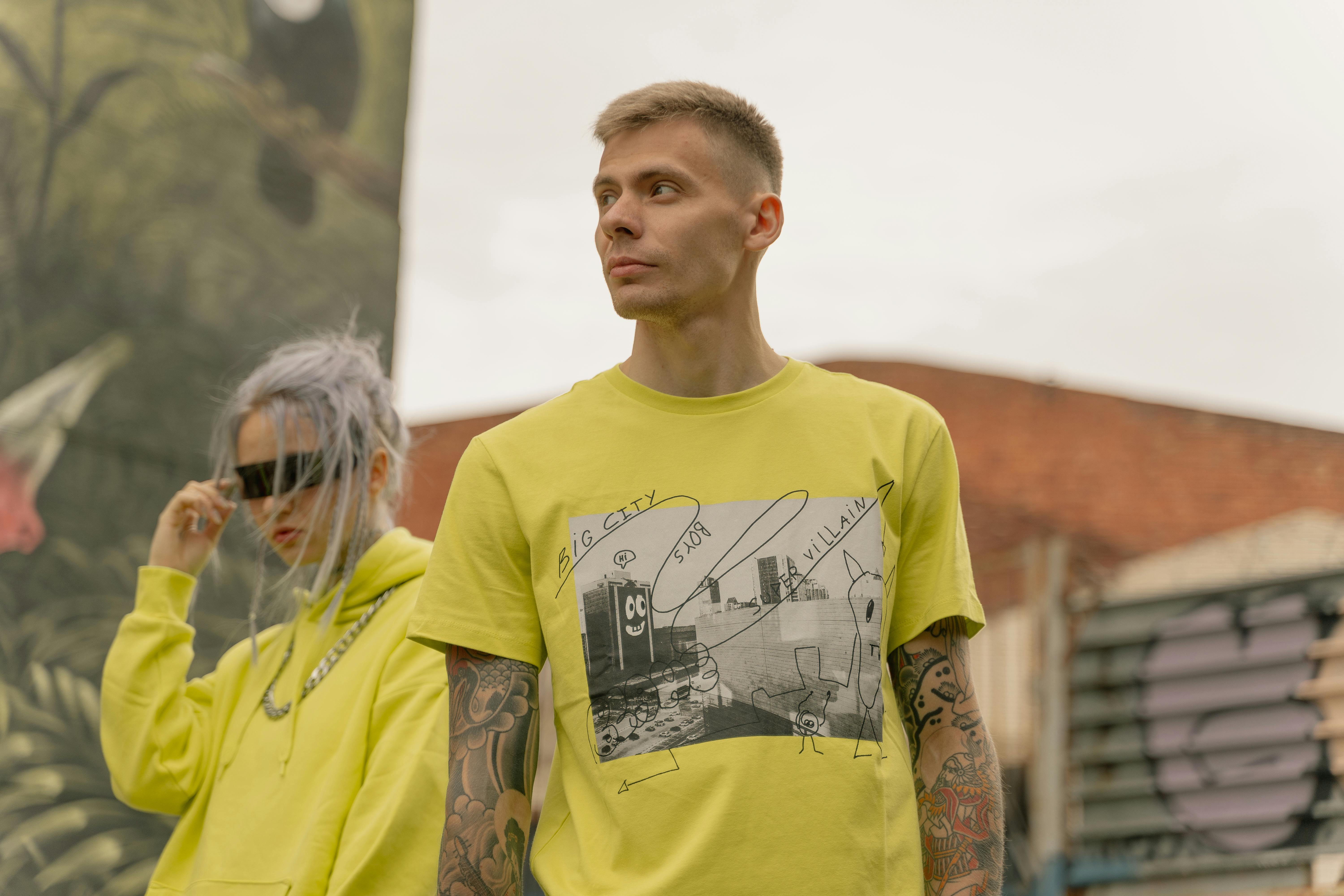 a man in a yellow shirt looking away