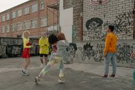 Group Playing Basketball in Alleyway