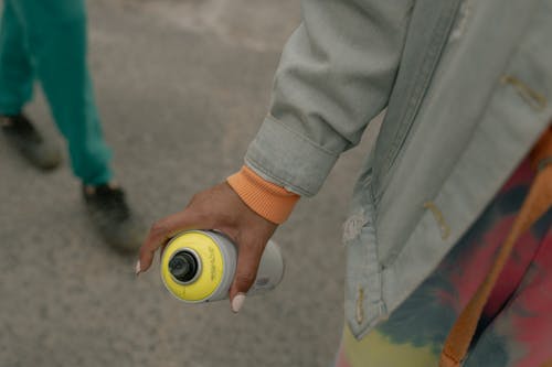Person Holding a Spray Paint