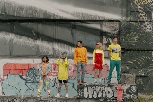 3 Boys in Yellow T-shirt and Gray Shorts Standing on Gray Concrete Floor