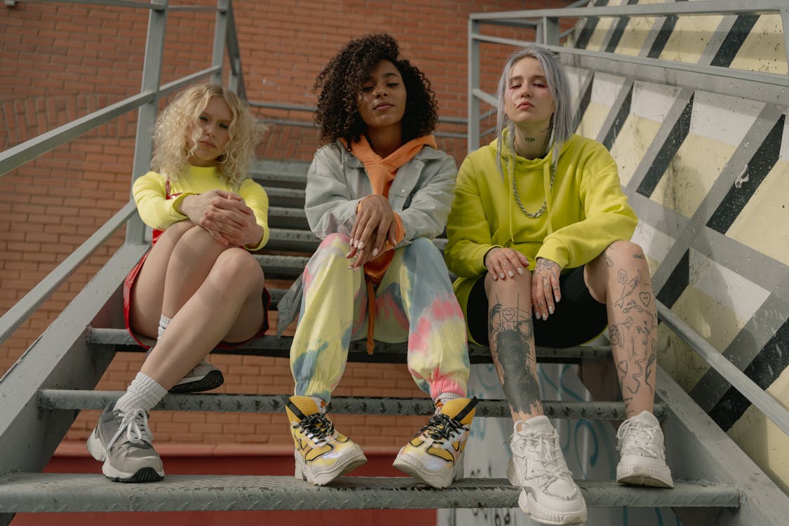 Photo of Stylish Women Sitting on the Stairs