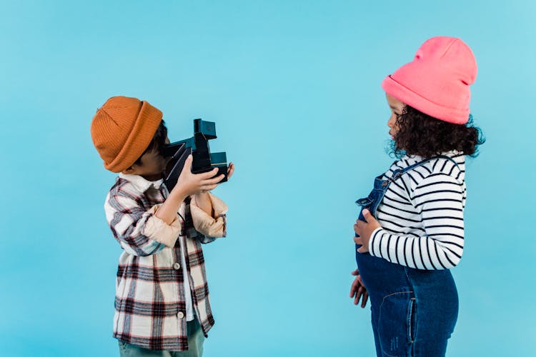 Multiethnic Anonymous Kids Standing In Studio With Photo Camera