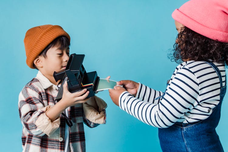 Curious Children Taking Instant Photo On Retro Photo Camera