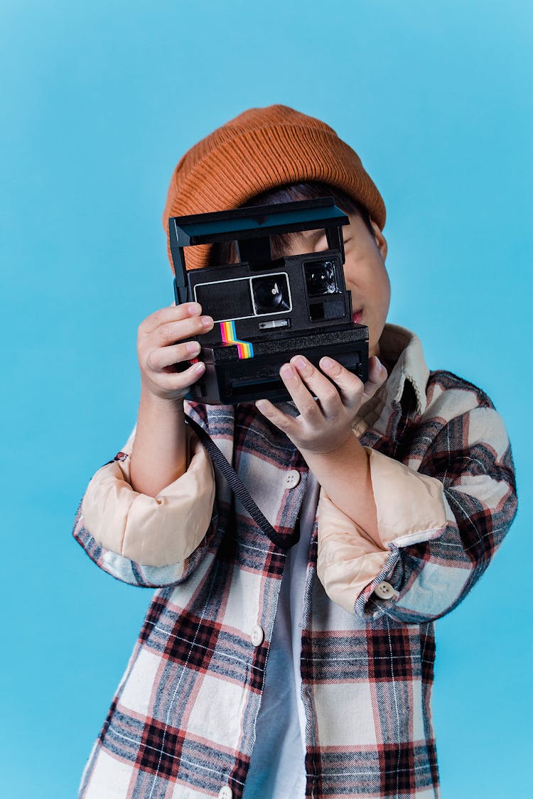 Little Boy Taking Photo On Retro Instant Photo Camera