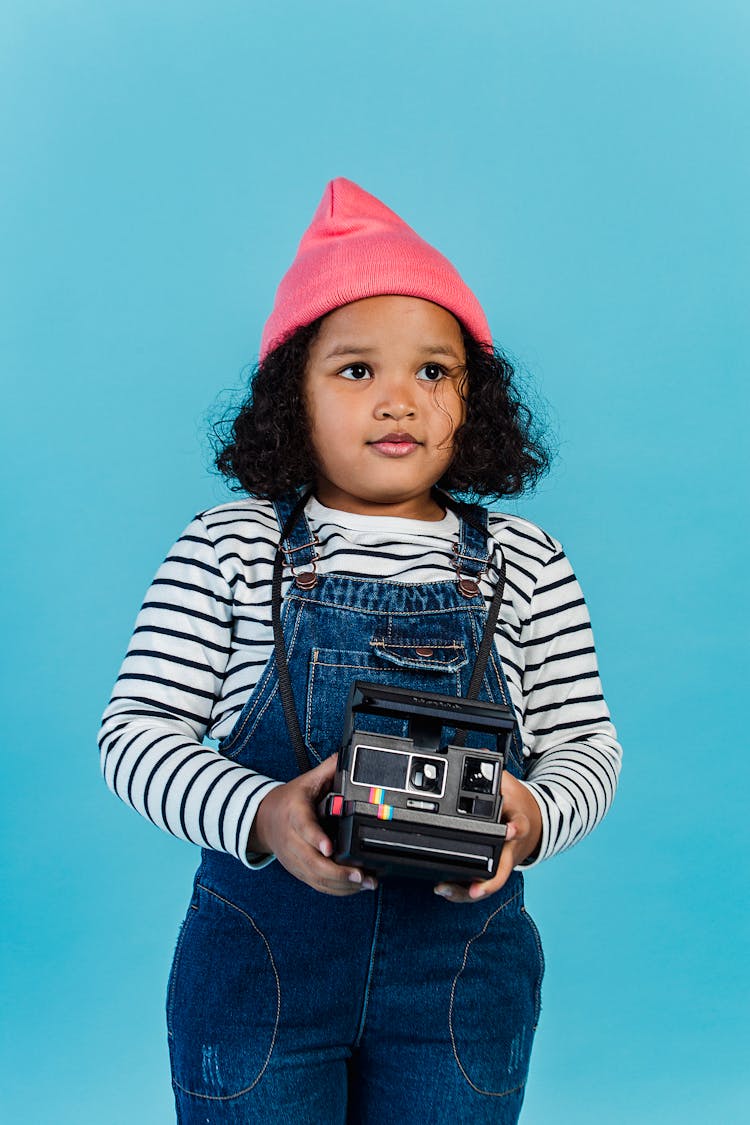 Thoughtful Black Girl Holding Instant Photo Camera And Looking Away