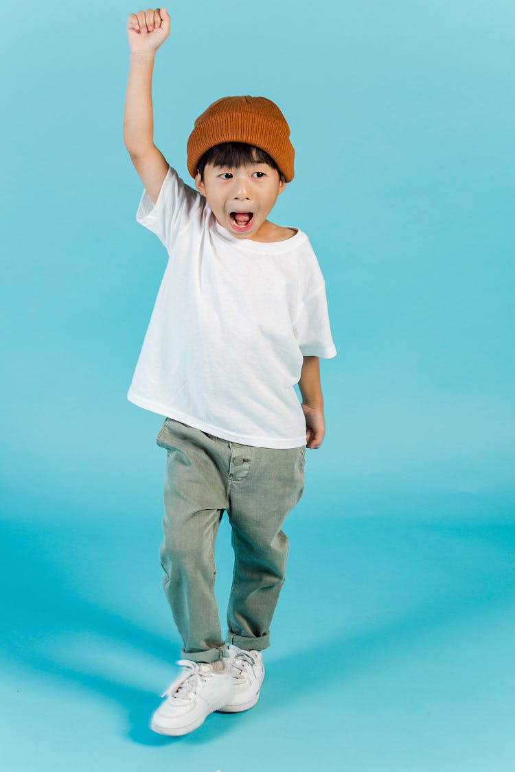 Happy Asian Boy With Raised Arm