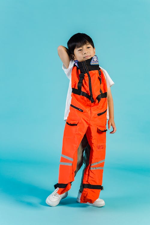 Boy In Orange And White Jersey Shirt And Pants