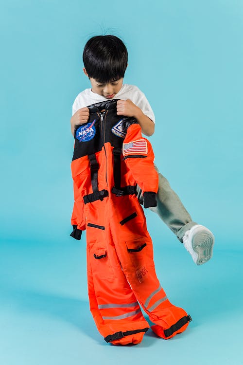 Cute Asian boy with cosmonaut suit
