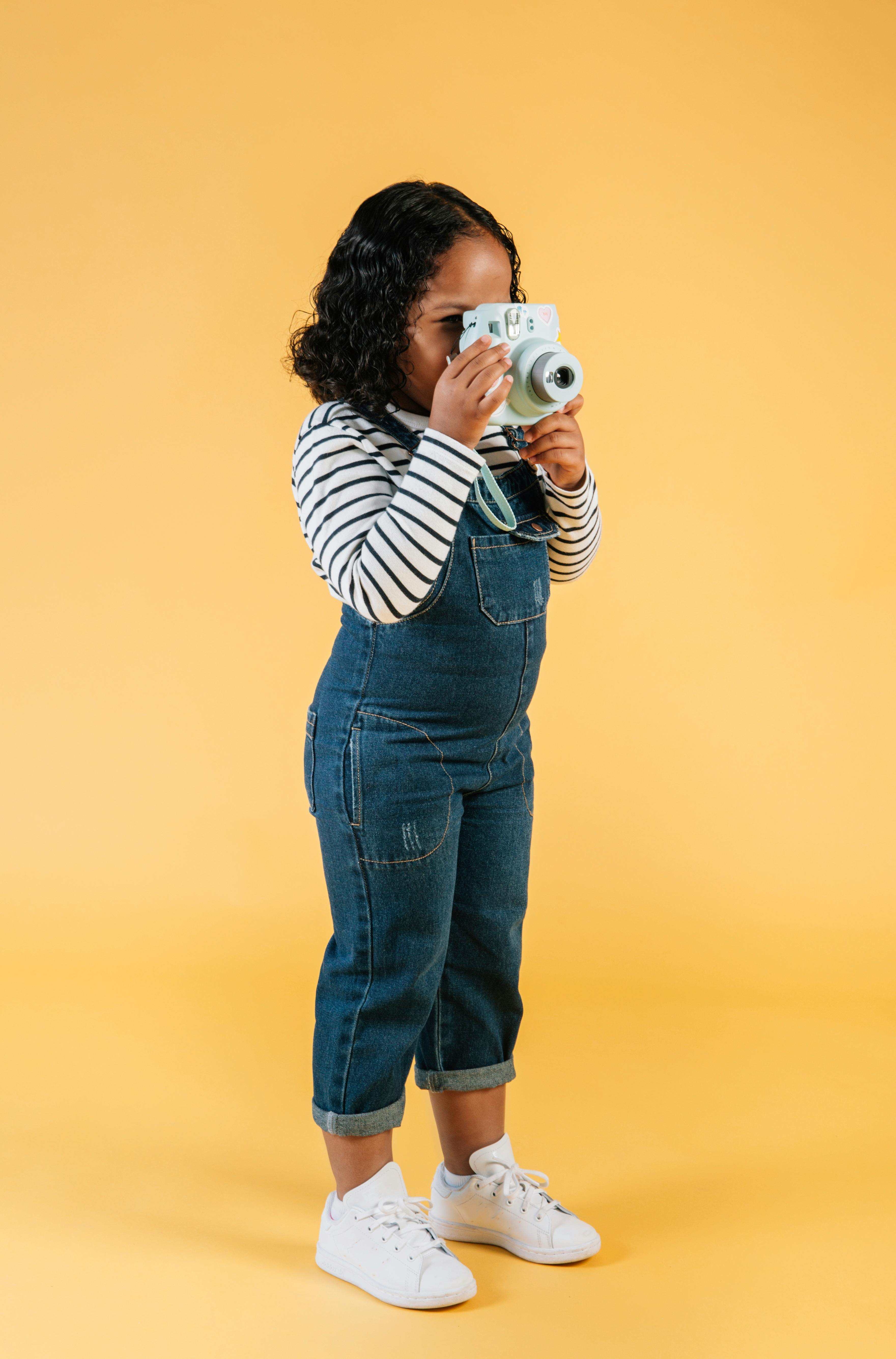 stylish black girl with photo camera