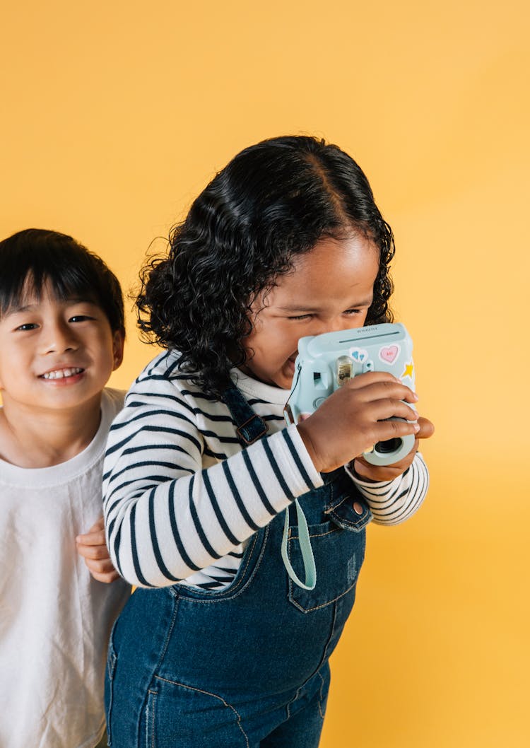 Cute Asian Boy And Black Girl With Photo Camera