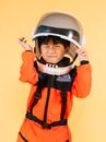 Boy in Orange and Black Zip Up Jacket Wearing Black and White Helmet