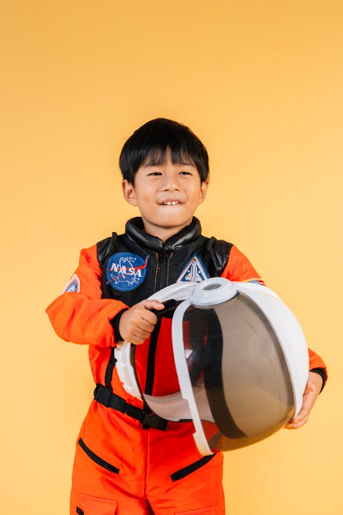 Cheerful Asian boy with astronaut helmet