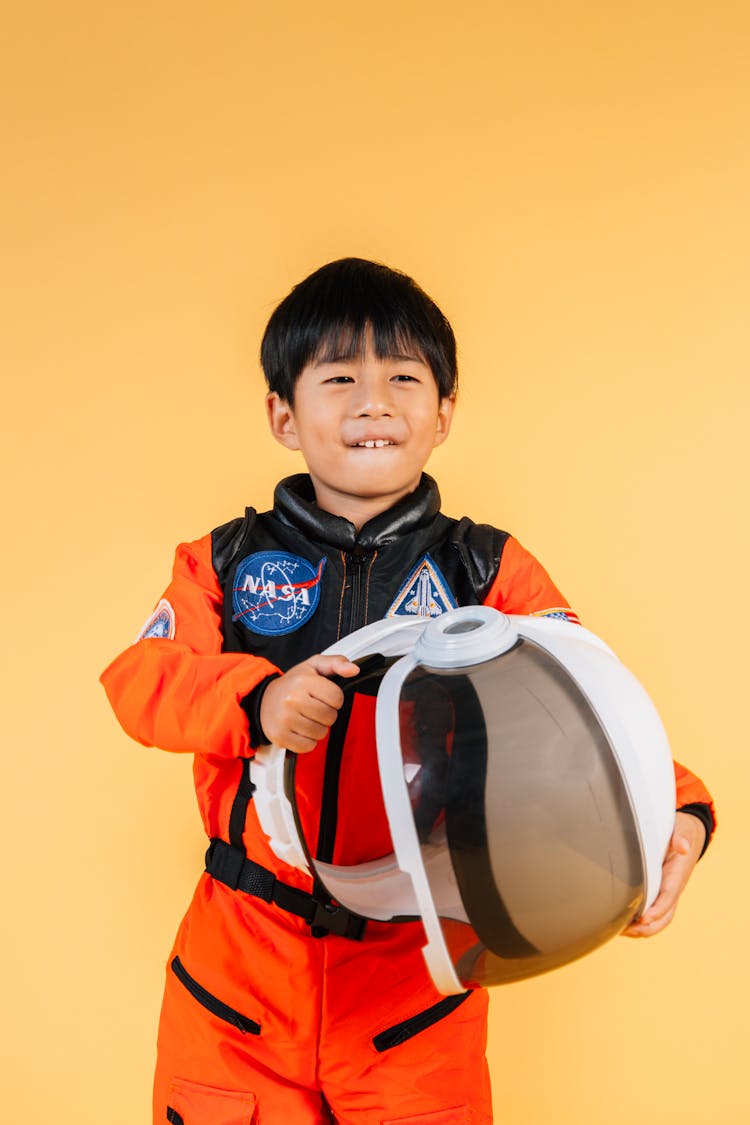 Cheerful Asian Boy With Astronaut Helmet