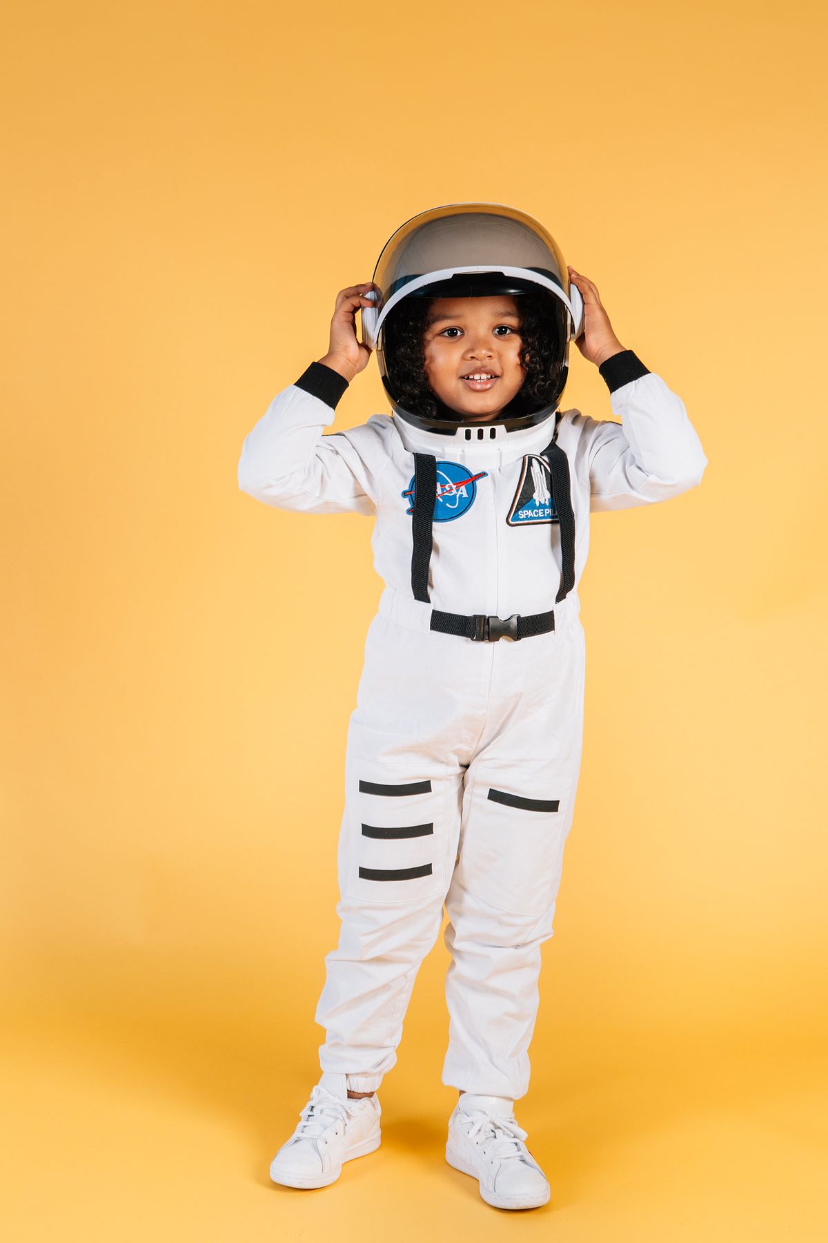 Child in a white astronaut suit with a helmet