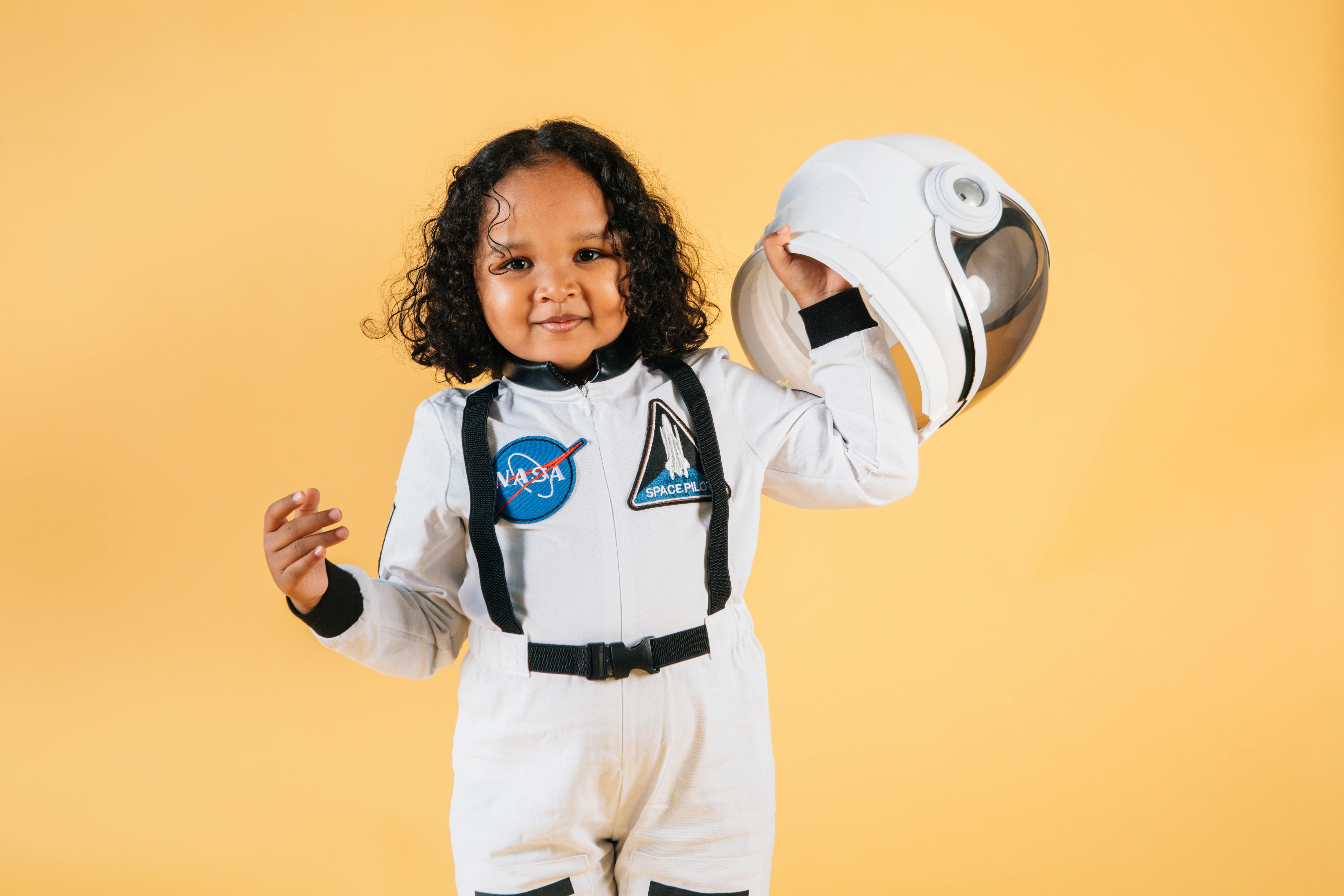 positive little ethnic girl with helmet