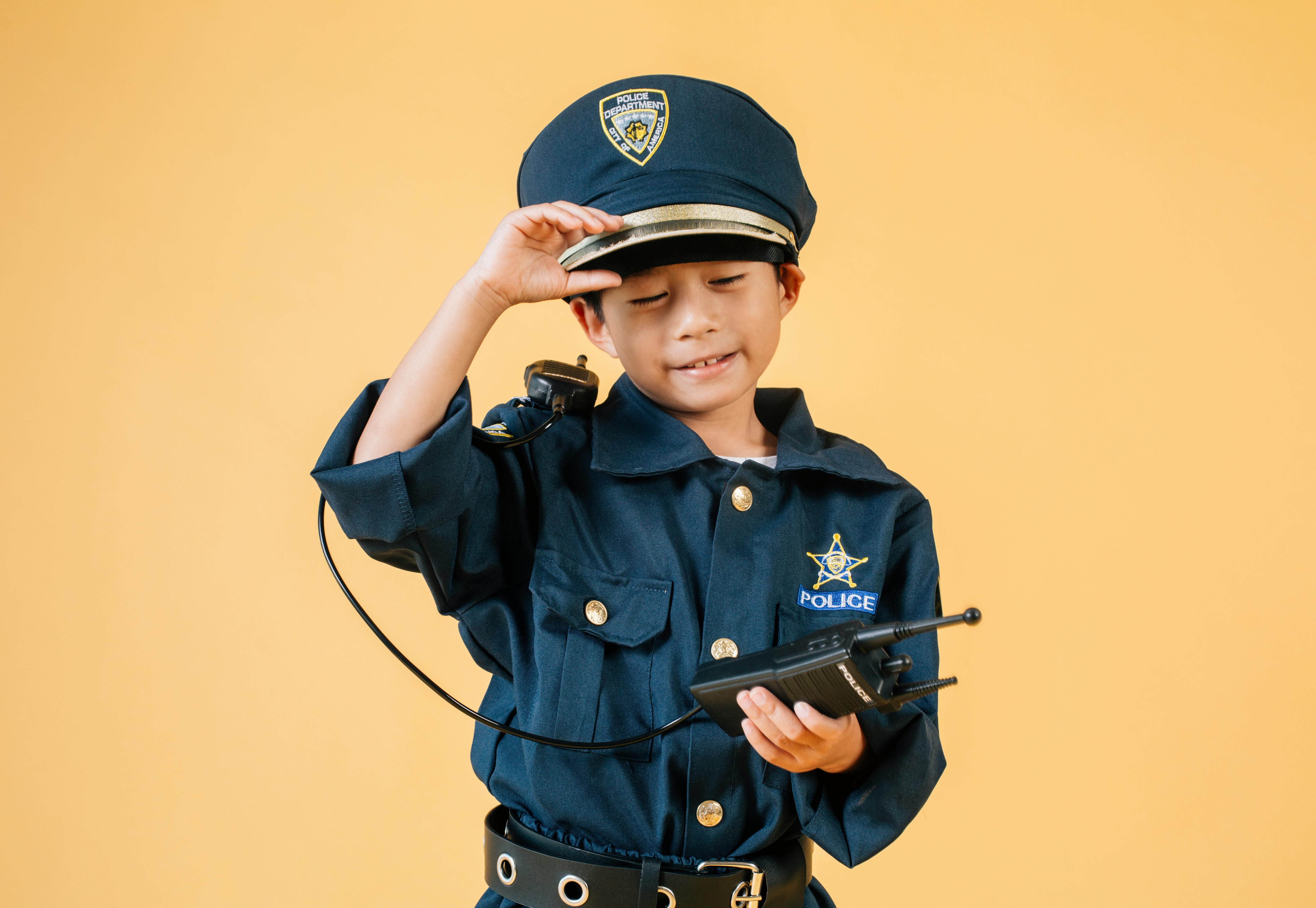 ethnic kid in police uniform in studio