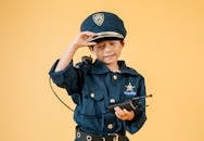 Ethnic kid in police uniform in studio