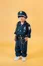 Asian child in policeman costume in studio