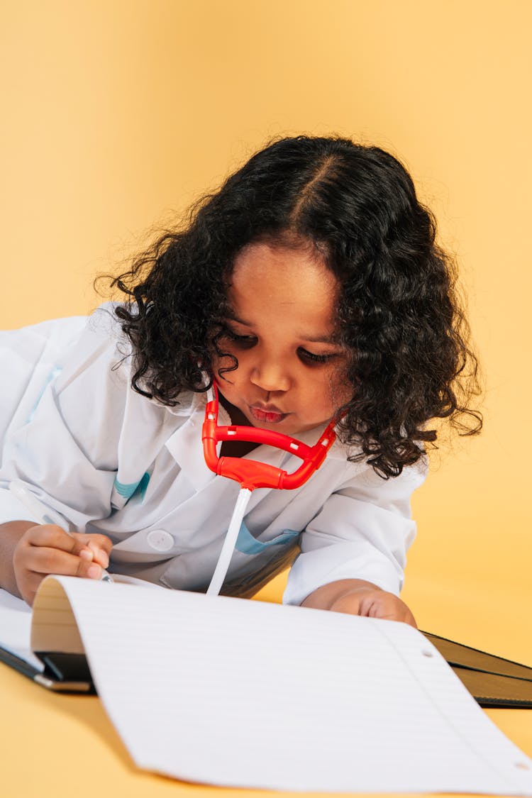 Black Female Kid In Doctor Costume In Studio