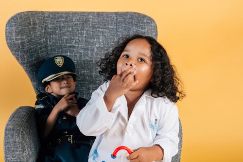 Children in job costumes playing together in studio