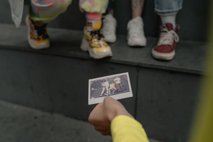 A Person Holding A Instant Photo