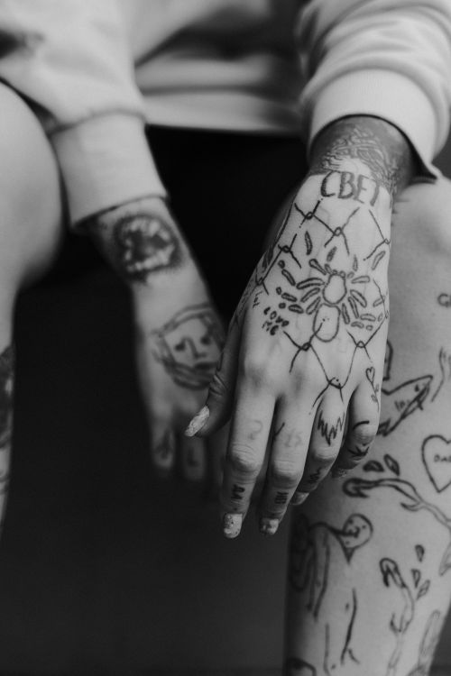 Free Black and white close-up of tattooed hands and arms showcasing intricate designs. Stock Photo