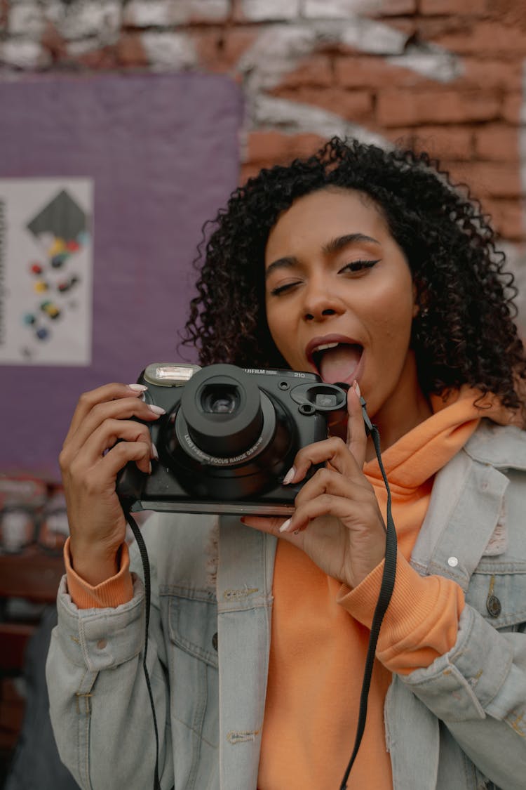 A Woman Holding Black Camera