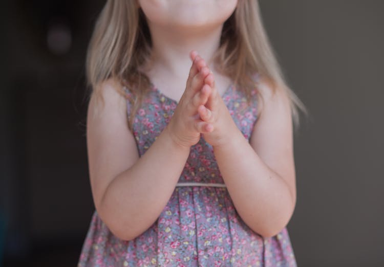 Unrecognizable Girl With Prayer Hands On Gray Background