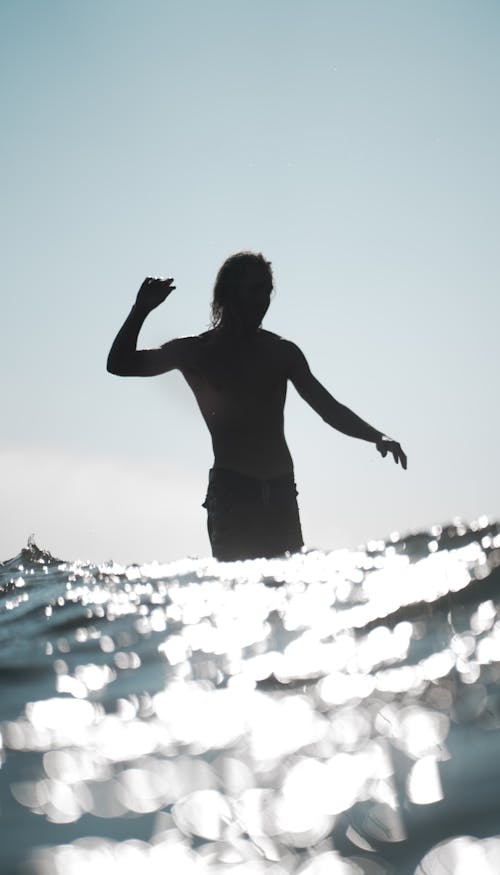 Silhouette of man in glow sea