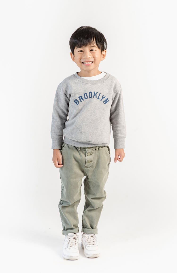 Happy Asian Boy In Stylish Wear In Light Studio