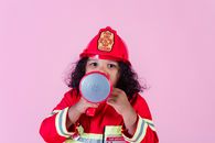 Cute black girl in firefighter uniform
