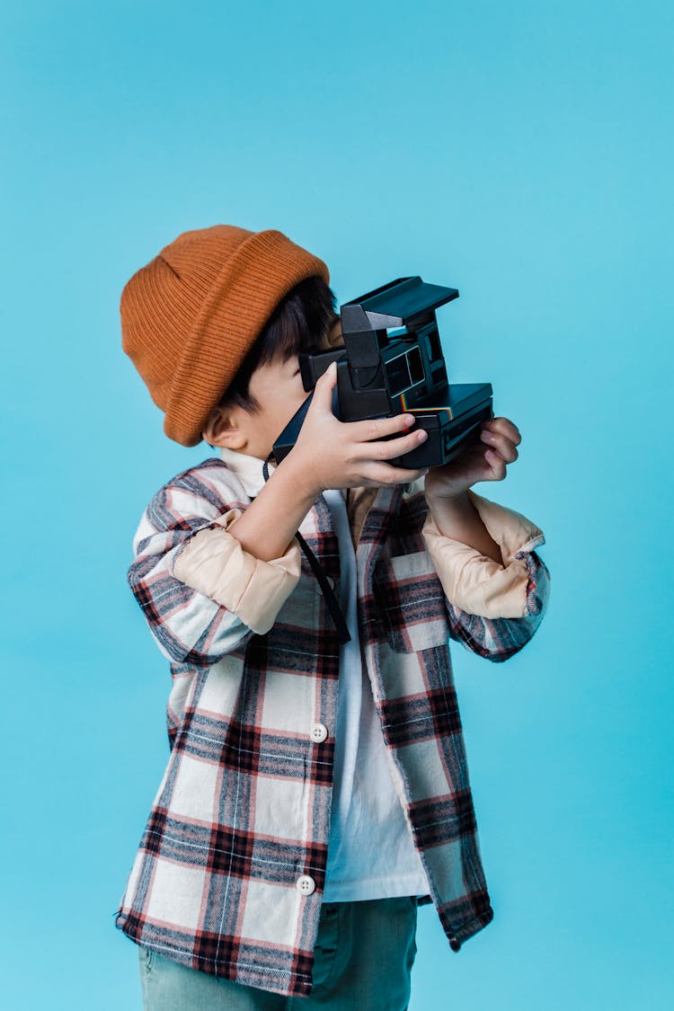 Cute Faceless Boy Taking Picture On Instant Camera