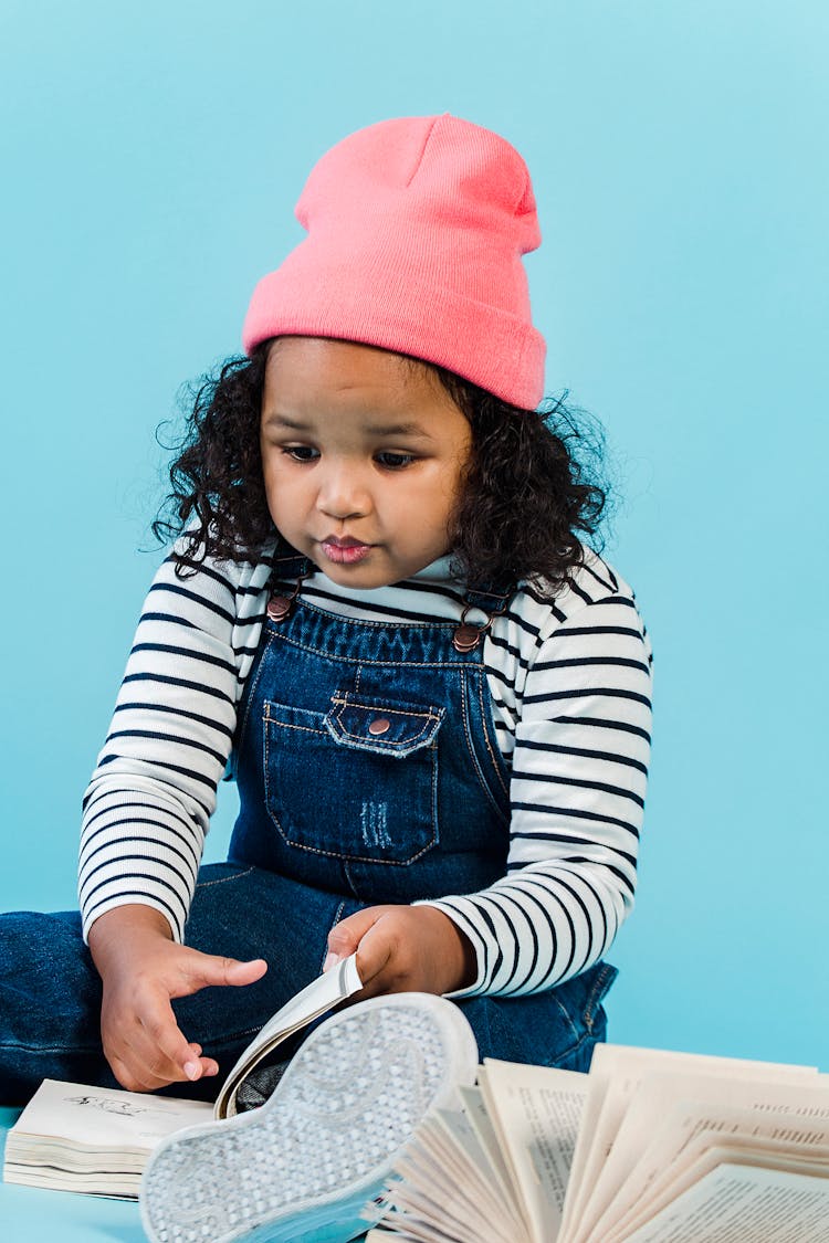 Content Black Girl Reading Book On Floor