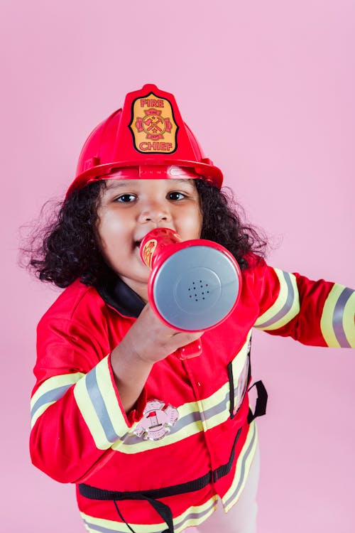 Content girl in firefighter uniform with megaphone