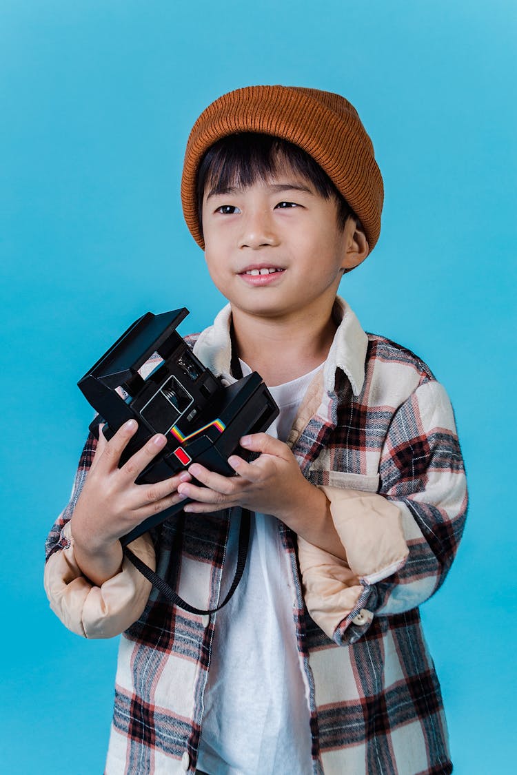 Cheerful Asian Boy With Retro Photo Camera