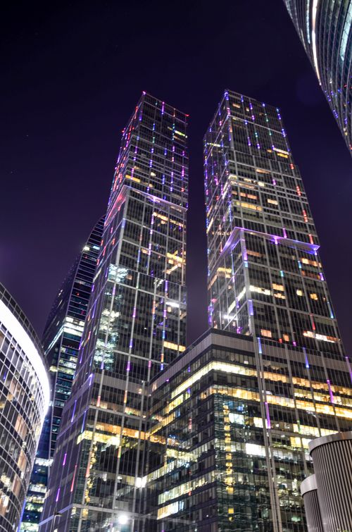 Free A stunning night view of illuminated skyscrapers in a bustling urban cityscape, showcasing modern architecture. Stock Photo