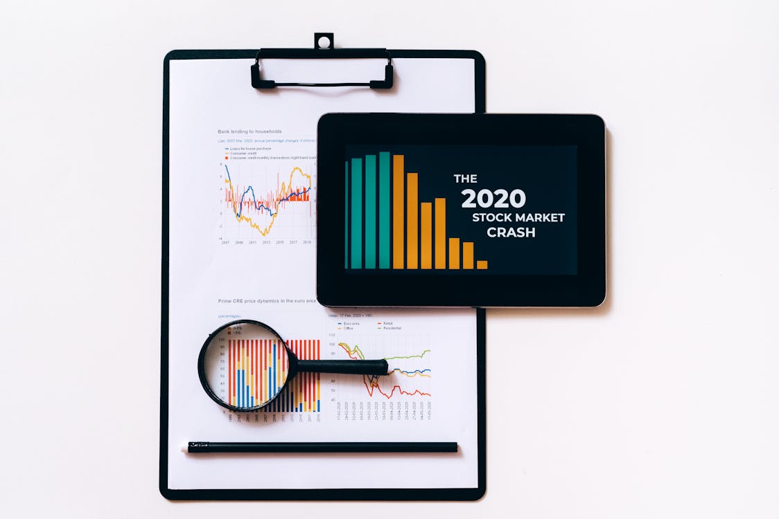 Clipboard with Statistical Data and Digital Tablet with  Stock Market Display on Screen