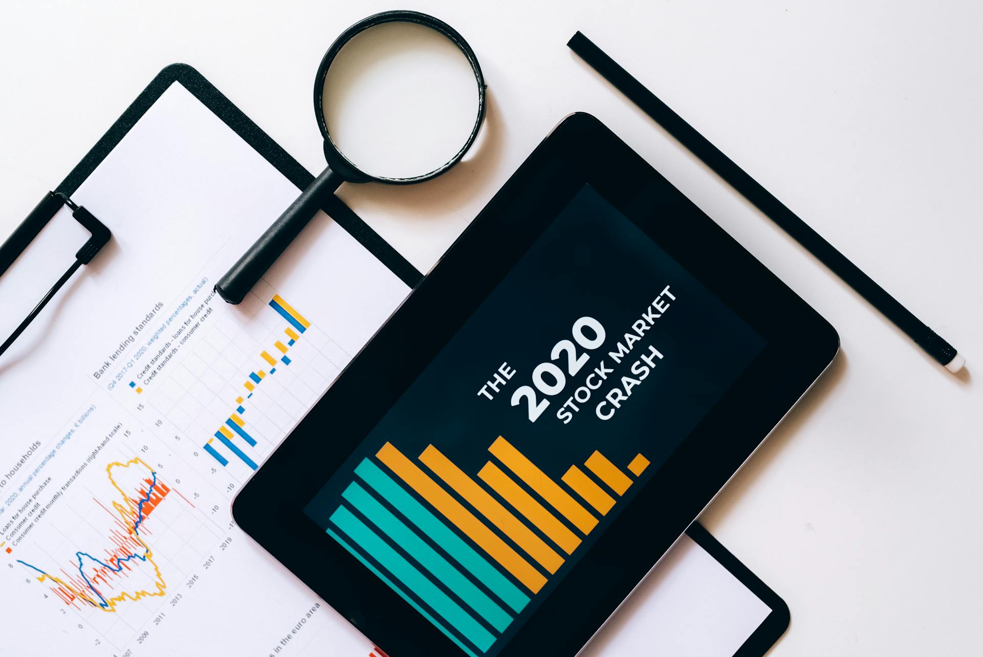 Clipboard with Statistical Data and Digital Tablet with Stock Market Display on Screen