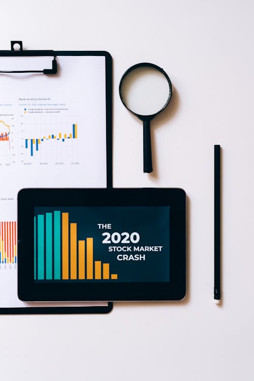 Free Clipboard with Statistical Data and Digital Tablet with Stock Market Display on Screen Stock Photo