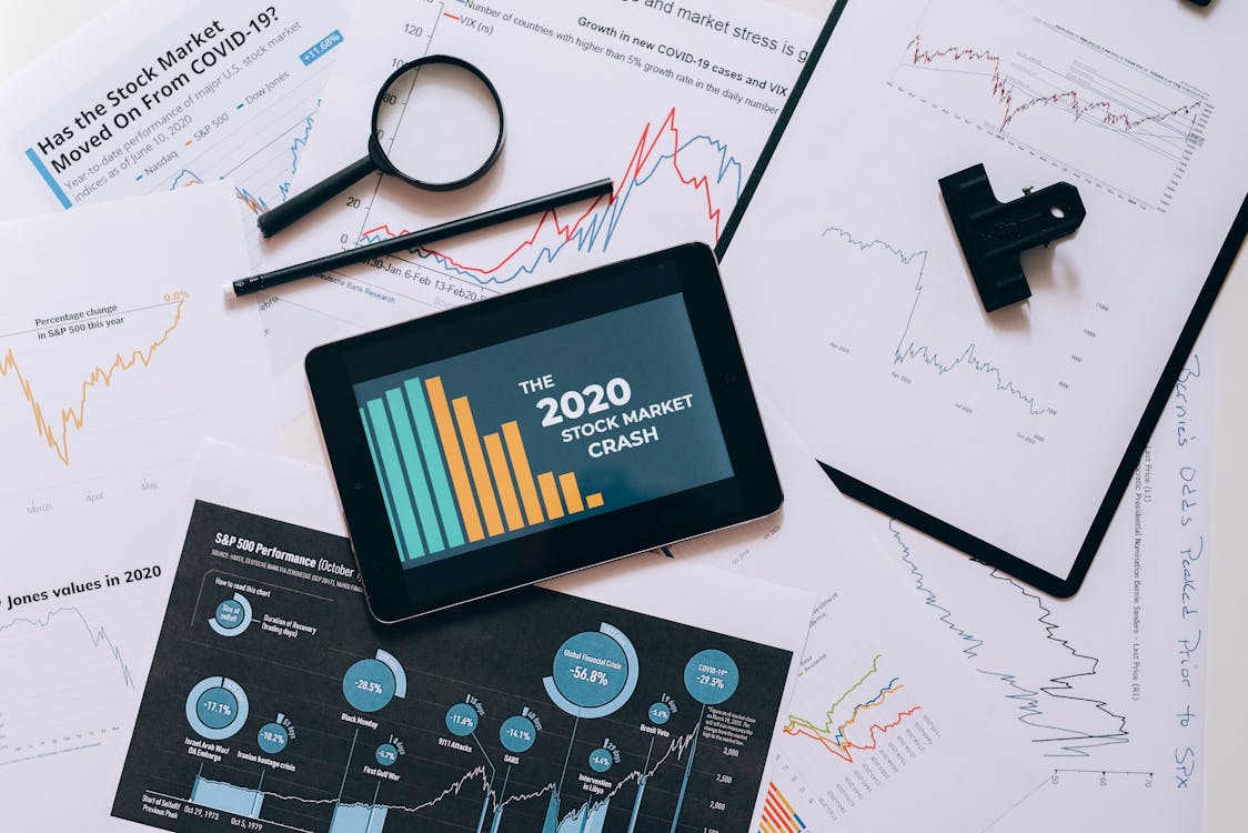 Free Clipboard with Statistical Data and Digital Tablet with Stock Market Display on Screen Stock Photo