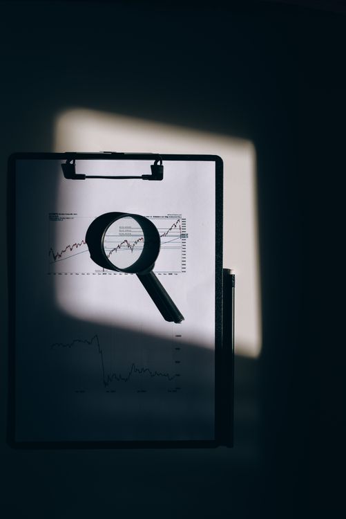 Magnifying glass held over paperwork representing close inspection and content detection