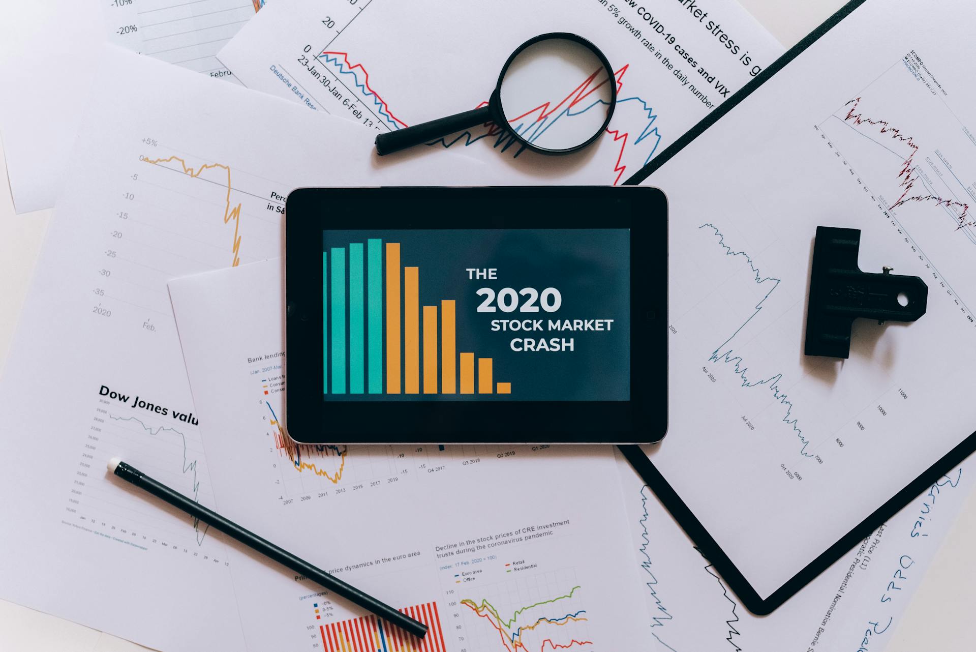 Clipboard with Statistical Data and Digital Tablet with Stock Market Display on Screen