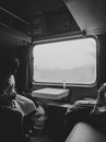 Grayscale Photo of Woman Sitting on Car Seat